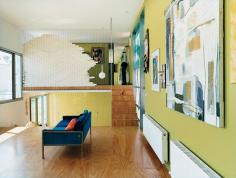 A mid-century Australian sofa discovered at a flea market and vibrant, eclectic art soften the architectural edges of the living room.