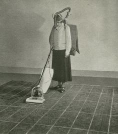 detail from Hoover : the story of a crusade. (1926) The marks on the carpet show how long each stroke should be and a metronome guides her in making a given number of strokes per minute. By measuring her carbon—dioxide exhalation while she works, the amount of energy required to sweep with different devices and in different ways—slow, fast, long strokes, short strokes, etc.—is accurately determined.