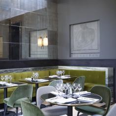 The aesthetic is lifted away from dull by the swirls and veins of the marble, the modern friezes rendered in classical style, and the olive green and fern upholstery. The gold central bar is another feature which architect Joseph Dirand has used to up the glamour factor...