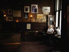 nationalgeographicmagazine: Café, Amsterdam | from “My Shot” by Marko Savic “In a hidden street I found this cafe. It looked like a scenography for some movie. I loved the atmosphere and the pictures on the wall. The lighting was really dramatic, and the man with the cigar was in just the right place.”