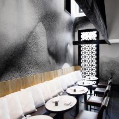 
                    
                        Swirling textured two-tone amorphous patterns sensually surround the diner, cut through with honeycombs, edges and cracked reflective surfaces which add further visual interest...
                    
                