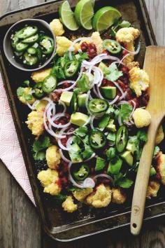 
                    
                        Crispy Cauliflower Nachos, topped with black bean chocolate chili, avocado, onions, pickled jalapenos, and cilantro! // From the Land we Live on
                    
                
