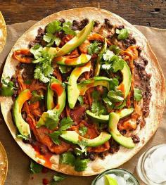 
                    
                        This tasty south-of-the-border pizza is topped with sausage, beans, cilantro, and avocado. More easy Mexican recipes: www.bhg.com/...
                    
                