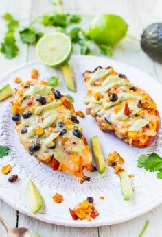 cheese black bean and corn stuffed sweet potatoes with avocado crema