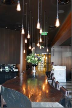 It’s big, bold and heavy. And it’s the first thing, apart from the maitre d’ that greets you upon entering. This signature restaurant comes with a signature piece of furniture ~ a ginormous $12,000 dining table made out of a single tree. Interior designer Paul Kelly’s team found the tree in Oberon near the Blue Mountains in country New South Wales. It was sliced in half and its jagged edges sanded down.