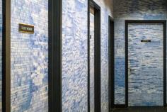 
                    
                        For a reprieve from the dark woods and polished luster of the dining room, take a break in the blue-and-white tile-lined bathroom area.
                    
                
