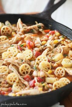 Southwest Chicken Chili Mac Skillet Style: 8 oz wagon wheel pasta noodles; 2 Tbls extra virgin olive oil; 1 C finely chop white onion; 1/2 C finely chop sweet peppers (or bell peppers); 1 tbls minced garlic; 2 C cooked shredded chicken breast; 10 oz can Rotel diced tomatoes mild; 1 1/2 C reduced sodium chicken broth; 1/2 C corn fresh or canned; 1/2 C white beans drained/rinsed; 1 Tbls chili powder; 1 Tbls ground cumin; 1 tsp dry Ranch seasoning from packet; 1/4 C finely chop fresh cilantro