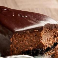 Chocolate Fudge Cheesecake Chocolate Crust 1 1/2 c (about 22 cookies) cream-filled chocolate cookie crumbs (such as Oreos), including the filling 3 T butter Cheesecake: 4 (8-oz) pkg cream cheese 1 1/2 c granulated sugar 5 eggs 1/4 c flour 1/2 t salt 1/4 c whipping cream 1 T vanilla 3 (1-oz) squares semisweet chocolate 1/2 c semisweet chocolate chips Chocolate Sour Cream Topping 3 T powdered sugar 2 t unsweetened cocoa powder 1 c sour cream 1 t vanilla