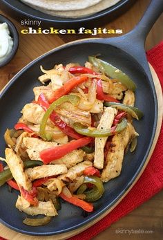 Skinny Chicken Fajitas - Lean strips of chicken breast, bell peppers and onions served sizzling hot with warm tortillas and shredded cheese. Any night can be an easy fiesta! #quick #Mexican #cleaneats #weightwatchers Swap the tortillas for lettuce leaves to make them #paleo