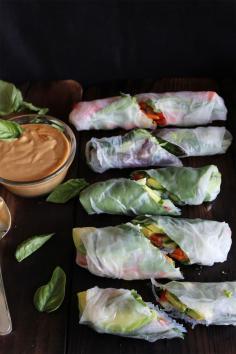 This Rawsome Vegan Life: fresh summer rolls with basil, avocado, kale + spicy garlic Peanut sauce: 2 garlic cloves, minced 1 tablespoon chunk of ginger, peeled and finely chopped 2 tablespoons each of tamari, maple syrup, and lime juice Chili powder, to taste 1/3 cup peanut butter 1/3 cup water (more or less as needed) 1 cup cooked vermicelli (AKA rice noodles) 5-8 rice paper sheets 1 carrot 1 avocado 1/3 cucumber 1 cup fresh basil 1/2 cup cilantro 5-8 kale leaves 1/2 red pepper