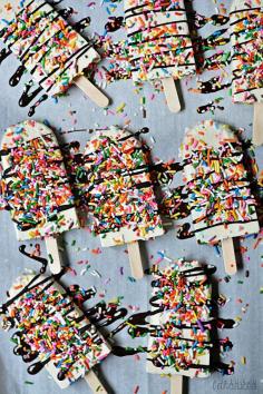 Creamy Funfetti Yogurt Pops! Vanilla Greek yogurt,  cake mix, cool whip, sprinkles & drizzled w/ melted choc. chips.