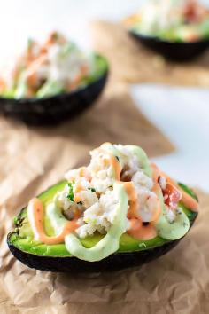 
                    
                        Seafood Stuffed Avocados! Halved avocados filled with shrimp, crab, and tomato and then drizzled with sriracha and avocado cream on top. | HomeamdeHooplah.com
                    
                