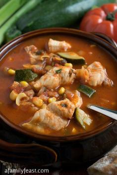 Italian Fish Stew - http://www.afamilyfeast.com - A taste of the coast in a bowl! Tender chunks of white fish in a tomato broth with fresh garden vegetables. Wonderful with warm crusty bread!