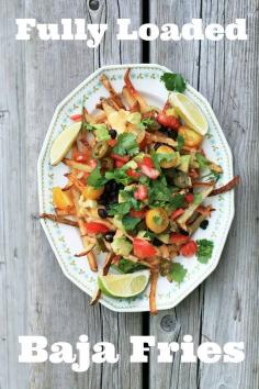 
                    
                        Fully loaded baja fries: Oven-baked fries topped with cheese sauce, avocado, black beans, and other yummy stuff! Click through for recipe.
                    
                