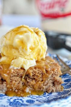 Cinnamon Roll Poke Cake is dangerously easy and tastes just like the gooey center of a cinnamon roll! This recipe starts with a spice cake mix and can of soda,comined with sweetened condensed milk, topped with vanilla ice cream and caramel sauce and you end up with the most delectable cake that ever lived! mouth watering recipe at TidyMom.net