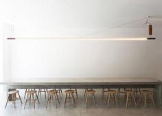 
                    
                        Torafuku restaurant features large communal concrete table
                    
                