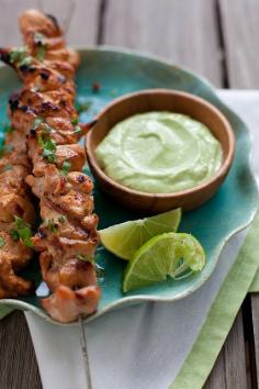 {Chipotle chicken kebabs and avocado cream sauce.}