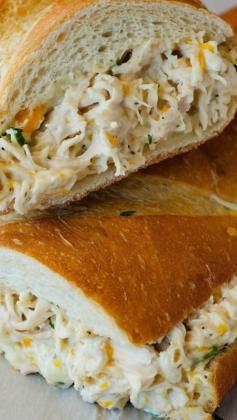 Chicken Stuffed French Bread |     	     1 loaf french bread     1 pound chicken breasts, cooked and shredded     1 1/2 cups Colby-Jack cheese, shredded     2 green onions, sliced thin     1 to 2 cups Ranch dressing  Instructions      Preheat oven to 375° F. Line a large baking sheet with parchment or wax paper.     Slice the french bread in half lengthwise. Place both halves cut side up on prepared baking sheet.     In a large bowl, mix together shredded chicken, cheese, green onions and enough