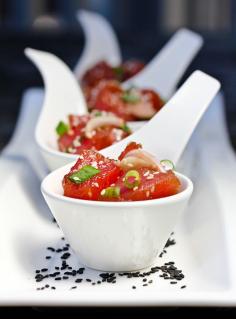 Hawaiian Ahi Poke: 2 large sashimi grade Ahi tuna steaks (1 1/2 lbs.) 1 shallot, sliced 1/2 cup chopped green onion 3 Tb. soy sauce 1 tsp. sesame oil 1 tsp. chili garlic sauce 1 Tb. sesame seeds