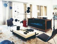 
                    
                        Navy sofa in modern living space with furry rug, white and black coffee table, and matching chairs // Italian design
                    
                