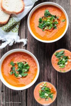 Easy Tomato Gazpacho Recipe | The Mediterranean Dish. Fresh, crisp and flavor-packed! You can make it in 15 minutes! Blend super ripe tomatoes with other chopped fresh vegetables, garlic and spice. Chill then add olive oil and a little herb garnish. And just like that, dinner is served! Or serve it as a party appetizer in small cups or even shot glasses!