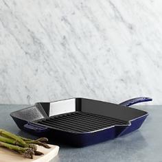 Griddles & Grill Pans - Durable cast-iron Staub square grill pan lets you enjoy authentic grilled flavor and healthier entrees, without firing up the grill. The natural heat-retentive properties of cast iron ensure food cooks evenly. Grill steaks, pork cutlets, seafood or hamburgers indoors, while draining away excess grease. This 10-inch grill pan elevates bacon, ensuring strips fry uniformly, without cooking in grease. With the black matte, slightly-textured enameled interior, this cast-iron stove top grill pan provides exceptional browning. The even-heating base, sidewalls and solid weight of this indoor grill pan allows searing at high temperatures to seal in moistness, flavor and add light-crisp texture. The Staub square grill pan makes restaurant-style panini sandwiches, Ruebens or grilled cheese sandwiches. Smooth enameled exterior in combination with the natural heat-retentive qualities of cast-iron creates durable, maintenance-free cookware, that does not require seasoning. The Staub 10-inch grill pan - Specifications Models: 1202923 (black), 1202987 (grenadine), 1202991 (dark blue), 1202906 (cherry), 1202918 (graphite) Material: enameled cast-iron 10" Sq. (16 3/4"L w/handles) x 1 3/4"H Base: 8 1/2" Sq. Weight: 7-lb, 6-oz. Made in France Care and Use Dishwasher-safe Oven-safe to 500 F and broiler-safe Suitable for gas, electric, glass, halogen and induction stove tops
