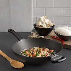 Scanpan is the first producer of nonstick cookware certified PFOA free, so ita s safe for your family and the environment. This professional-quality wok is great for stir-frying, steaming, deep-frying, sautA ing, braising, and more. Little to no added fat is required for cooking, so you can enjoy a healthy meal with minimal cleanup. Heavy-duty pressure-cast aluminum body features a thick base, ensuring fast and even heat distribution. Patented ceramic titanium nonstick cooking surface is impossible to scrape away, even with metal utensils. Wok is guaranteed not to blister, peel, or create hot spots. Sturdy, ergonomic handle stays cool during stovetop cooking. Dishwasher safe, but hand washing recommended. Oven safe to 500A°F. Lifetime warranty. Made in Denmark.