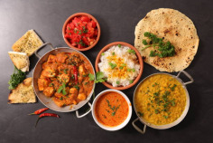 assorted of indian dish with curry dish, naan, chicken