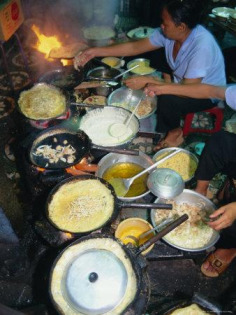 Photographic Print decor by Tim Hall. Cook in Restaurant; Ho Chi Minh City (Formerly Saigon); Vietnam; Indochina; Southeast Asia; and other photography; color photography; food & beverage (color photography); food (color photography) wall art; posters; and prints for home wall coverings are available.